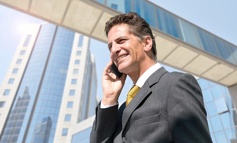 Businessman with cellphone outdoors